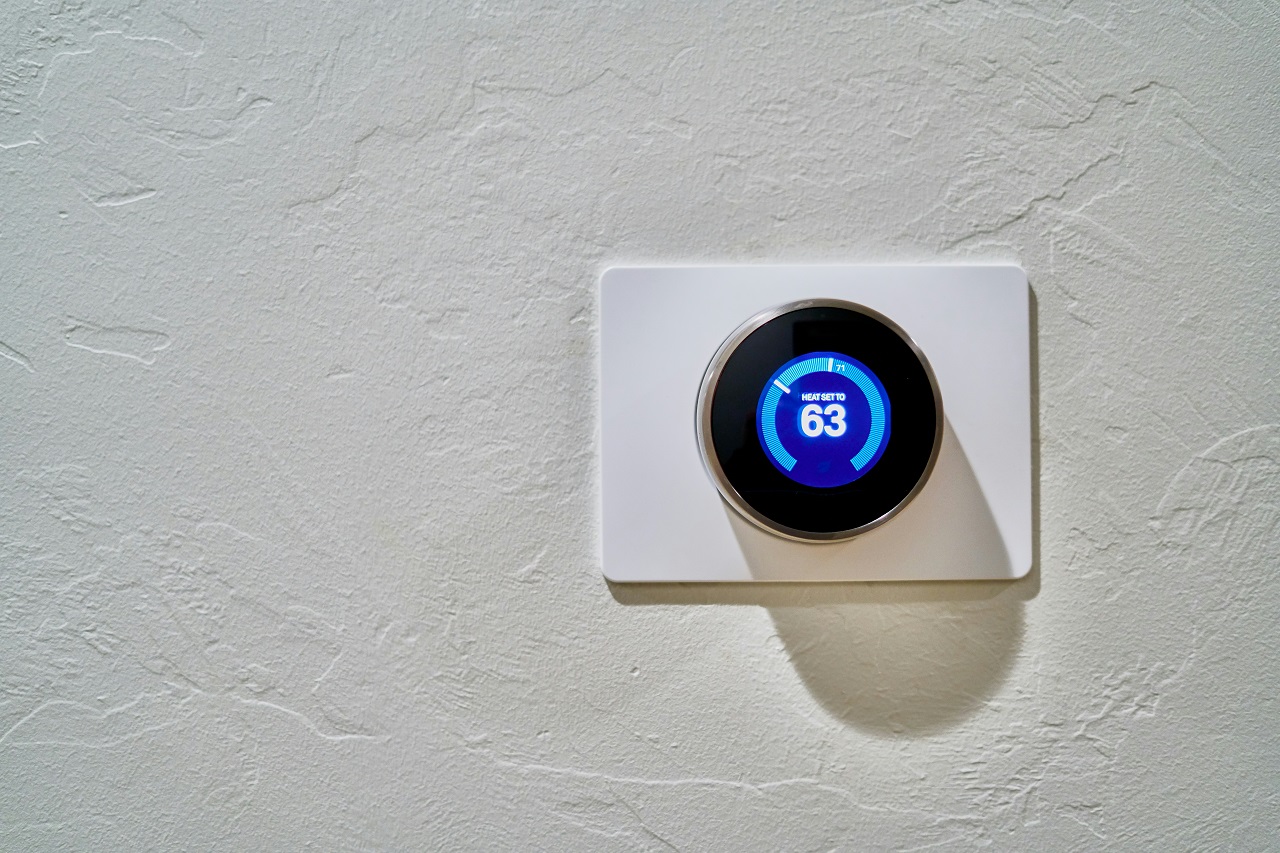 A smart thermostat installed in a wall at Topeka, Lawrence, KS